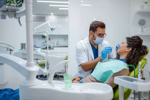 Dentist performing dental bridge consultation in modern clinic